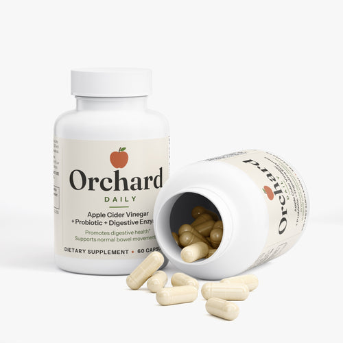 Open bottle of Orchard Daily with capsules spilling out